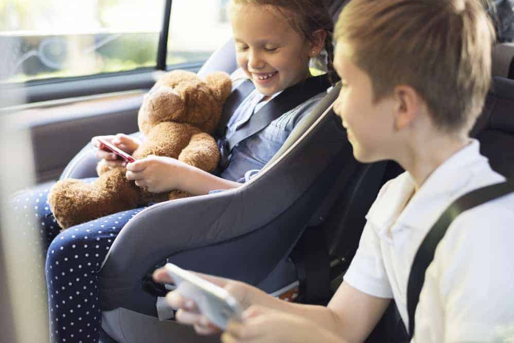 Travel essentials for kids on a road trip, electronics, stuffed animal