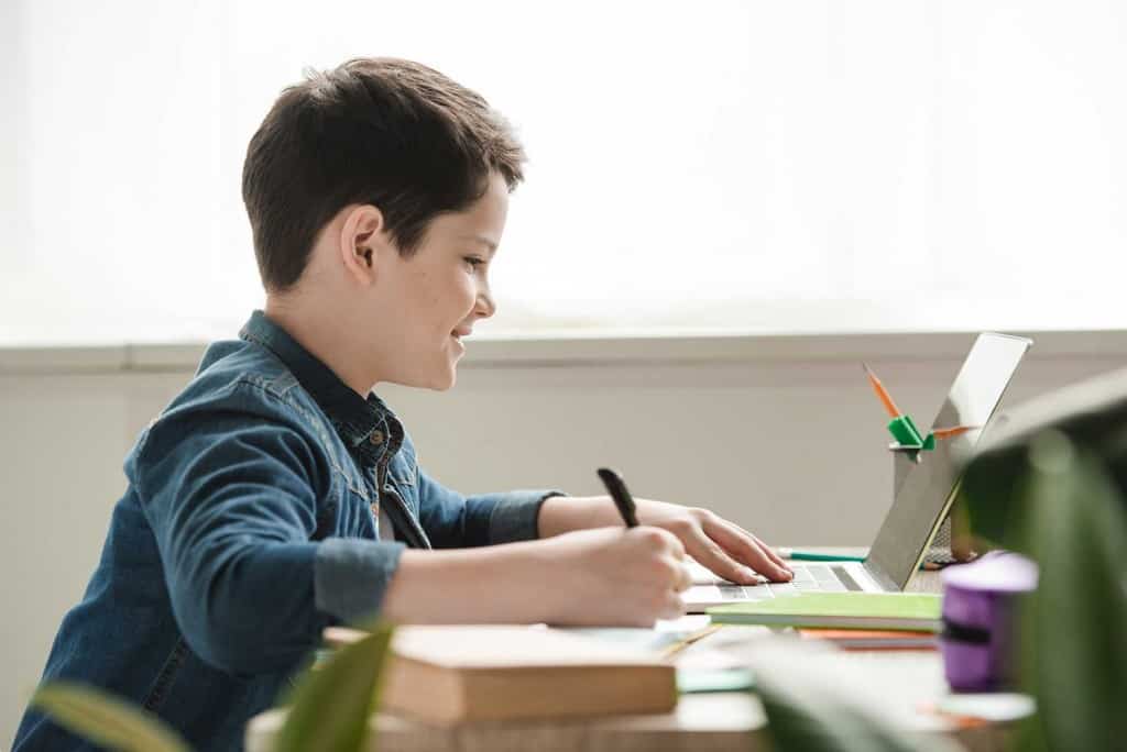 boy homeschooling on computer