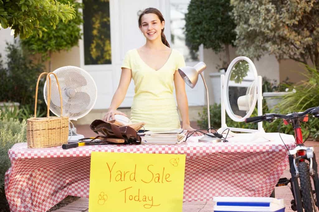 young girls making money at yard sale