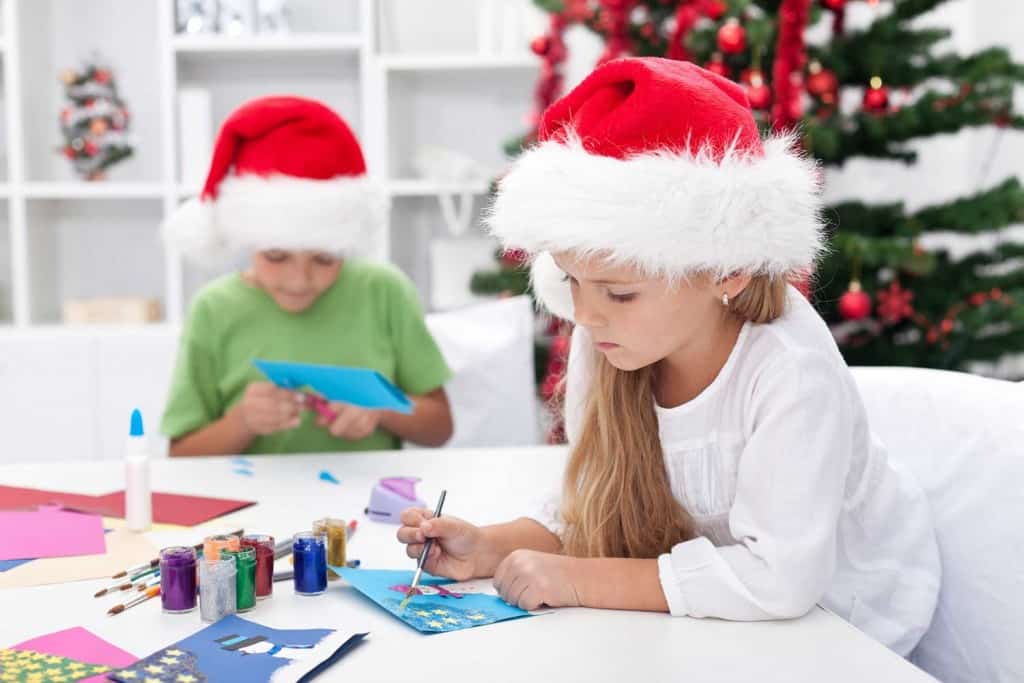 kids making homemade Christmas cards with paint and glitter