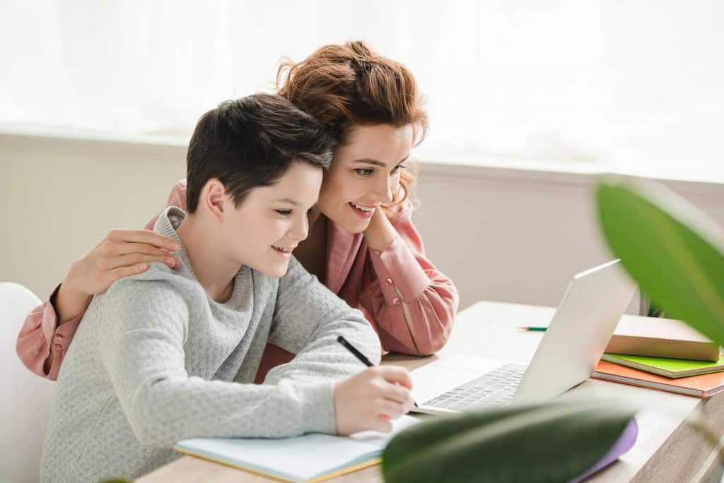 mom and son completing homeschool assignments together
