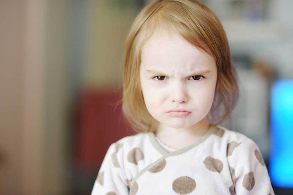 toddler girl with angry face and pursed lips
