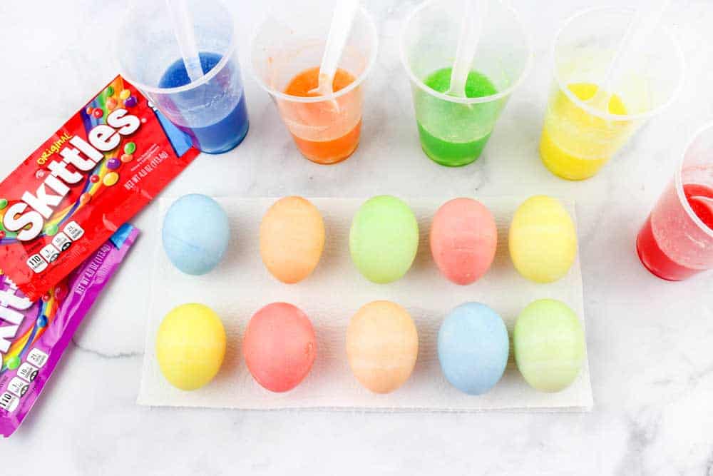 5 cups of skittles dye with 12 completed hard-boiled eggs