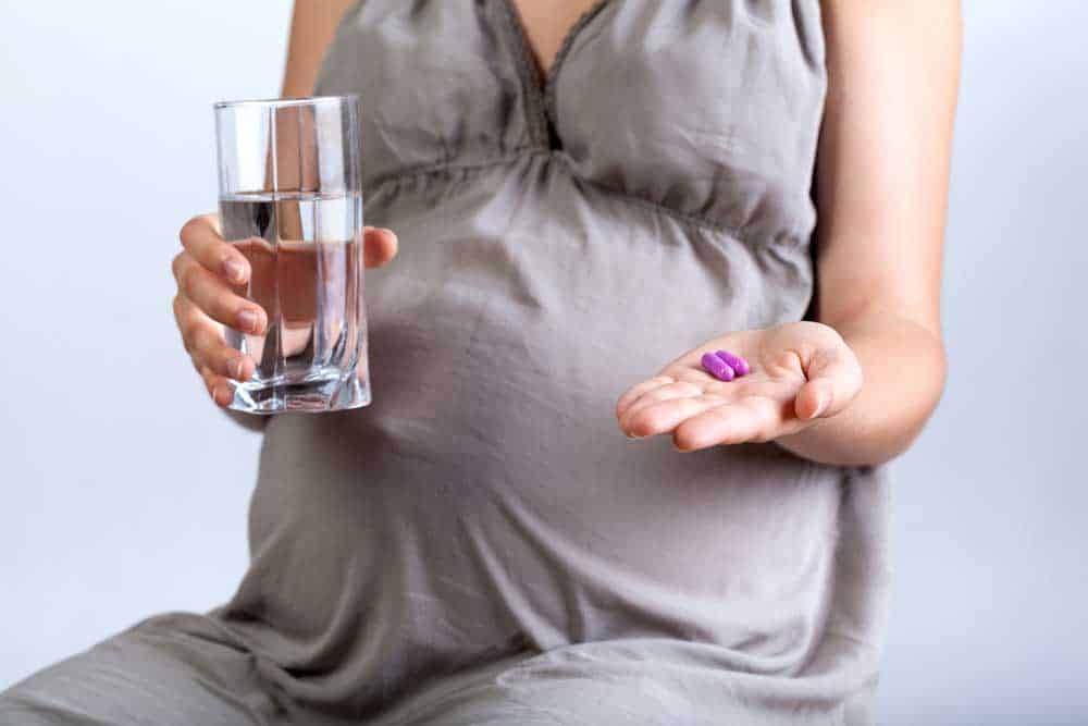 pregnant mom taking prenatal vitamins